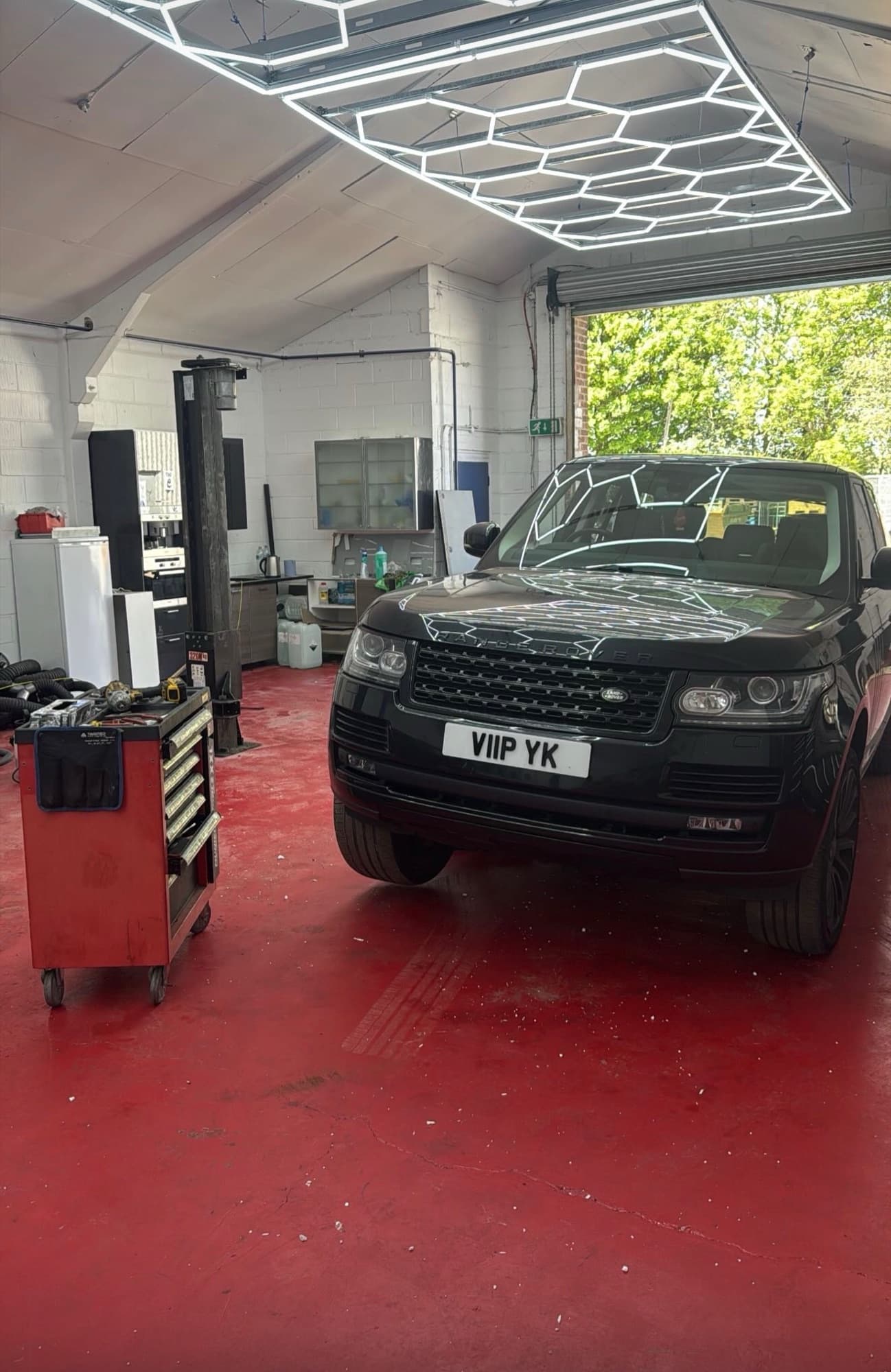 Range Rover under hexagonal lighting at LRC Autoworks
